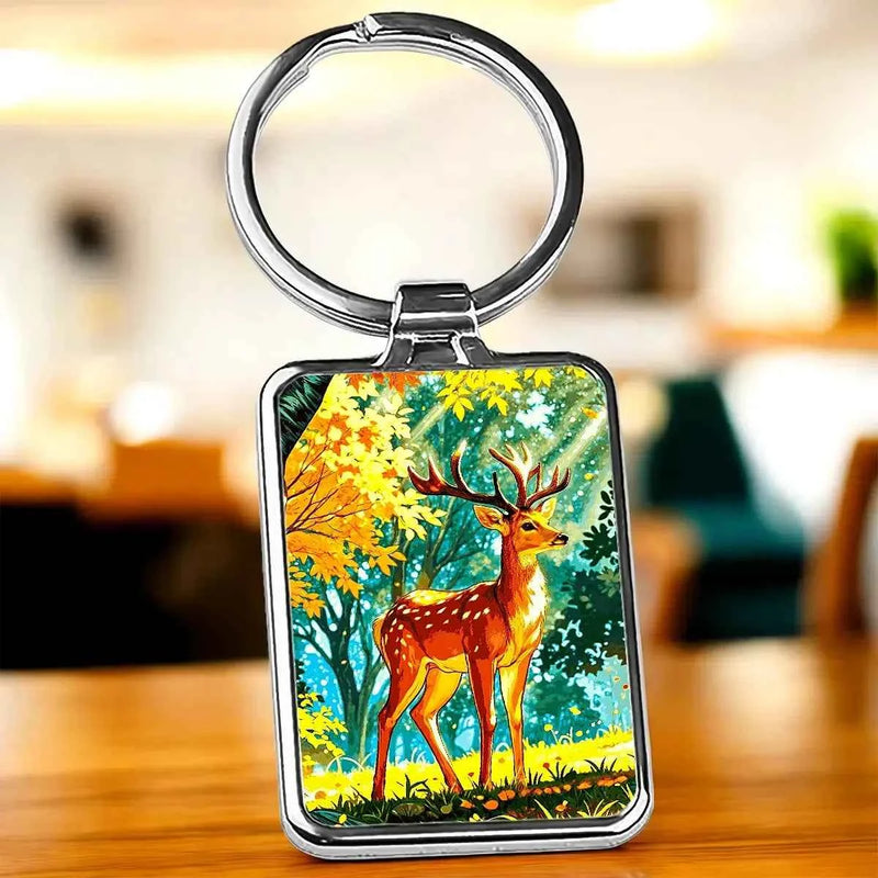 Porte-clé illustré d'un cerf majestueux dans une clairière automnale dorée, dessin artisanal cerf dessin